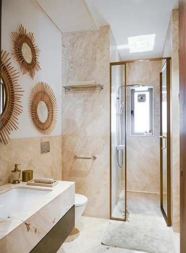 Interior view of a clean and well-lit washroom with white tiled walls, modern fixtures, and a large mirror above the sink