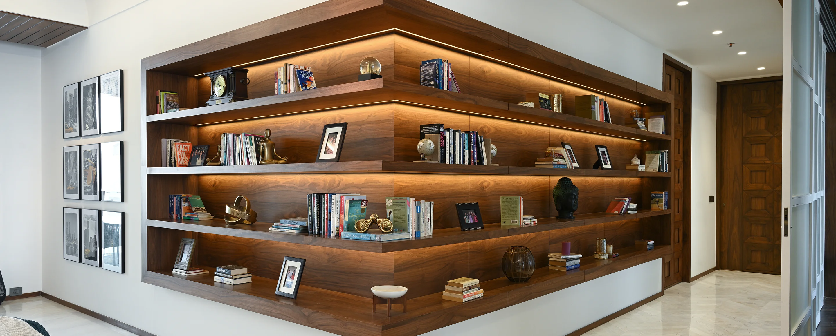 Schematic Design interior surrounded by bookshelf and photo frames.