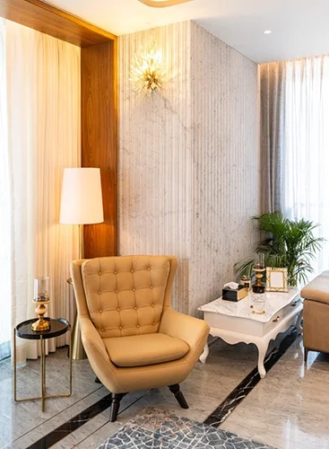 a cozy living room featuring a comfortable sofa, an elegant chair, and a stylish lamp illuminating the space.