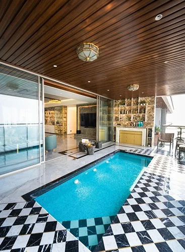 a contemporary apartment pool adorned with a checkered floor, exemplifying modern design and sophistication.