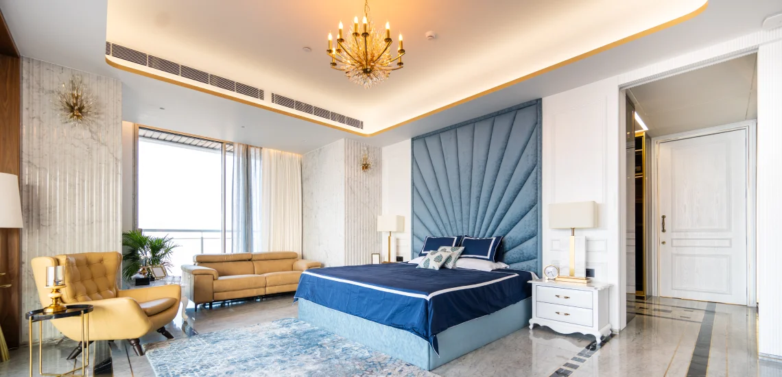 a stylish bedroom adorned with blue and gold accents, showcasing a blend of sophistication and comfort.