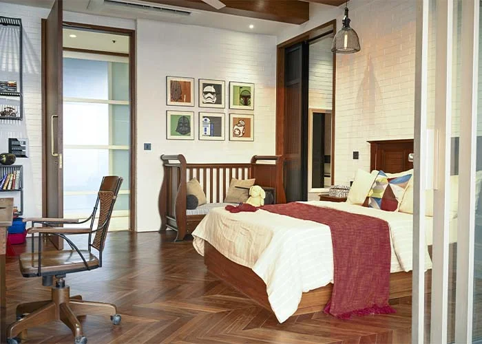 DESIGN CHRONICLES Stylish teenager's bedroom with a modern industrial design featuring white brick walls, wooden flooring, Star Wars-themed wall art, a cozy bed, and a functional study area.