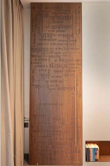 A wooden door adorned with text, situated in a room, highlighting unique design elements and artistic expression.