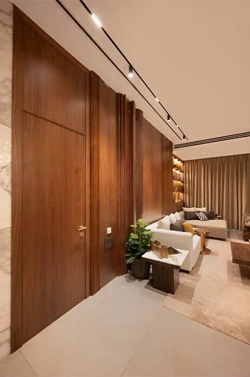 A stylish modern living room showcasing rich wooden paneling and polished marble flooring, exuding luxury and comfort.