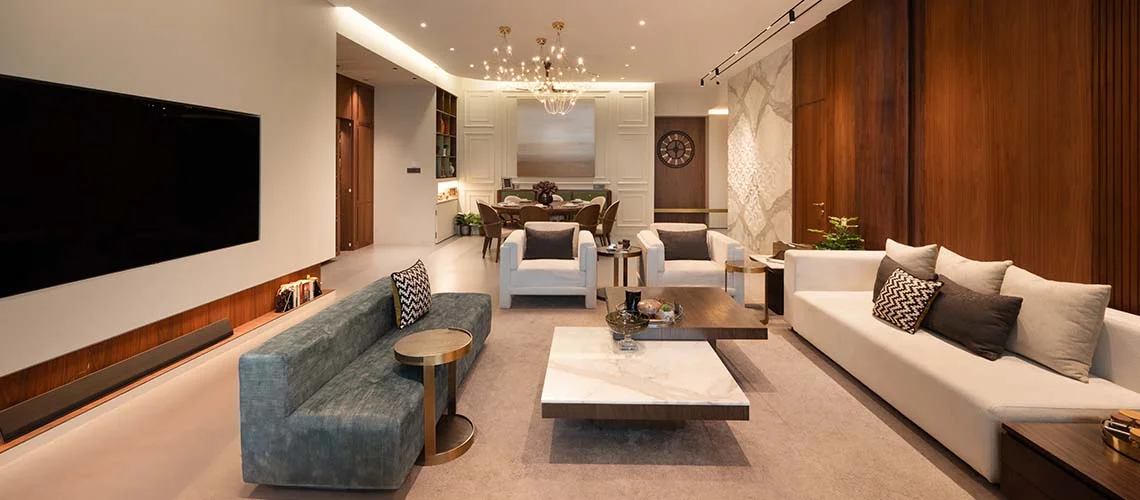 A contemporary living room featuring a spacious layout and a large flat screen television as the focal point.