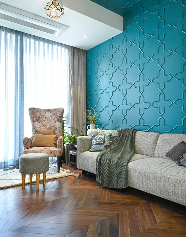 Luxury Interior Designer, a cozy living room featuring blue walls and warm wooden floors, creating a welcoming atmosphere for relaxation.