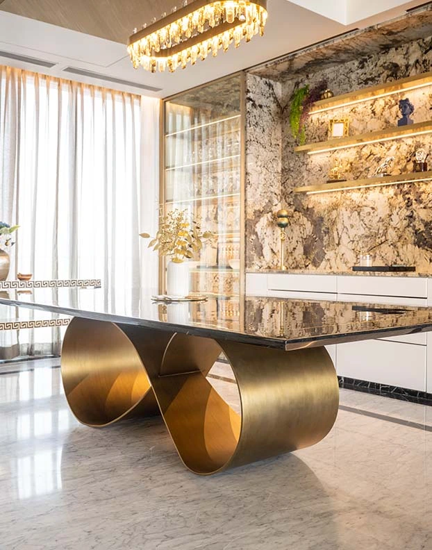 A contemporary dining table featuring elegant gold accents, showcasing a blend of modern luxury Interior designer.