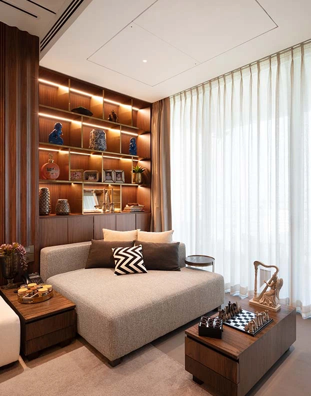 7Nirvana Luxury Interior Designer A contemporary living room featuring elegant wooden paneling and a stylish couch, creating a warm and inviting atmosphere.